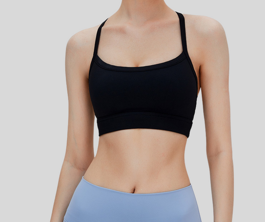 Sleek and supportive, this black bra top features a stylish T-back design with slim shoulder straps for enhanced comfort and freedom of movement. Made from breathable, stretchable fabric with a snug under-bust band, it's ideal for medium-impact activities like weight training, pilates, spinning, and barre.
