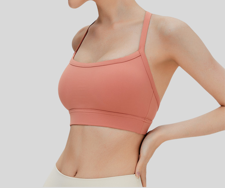 Sleek and supportive, this black bra top features a stylish T-back design with slim shoulder straps for enhanced comfort and freedom of movement. Made from breathable, stretchable fabric with a snug under-bust band, it's ideal for medium-impact activities like weight training, pilates, spinning, and barre.