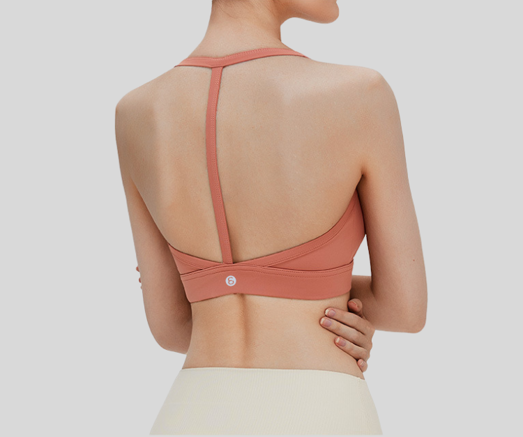 Sleek and supportive, this black bra top features a stylish T-back design with slim shoulder straps for enhanced comfort and freedom of movement. Made from breathable, stretchable fabric with a snug under-bust band, it's ideal for medium-impact activities like weight training, pilates, spinning, and barre.