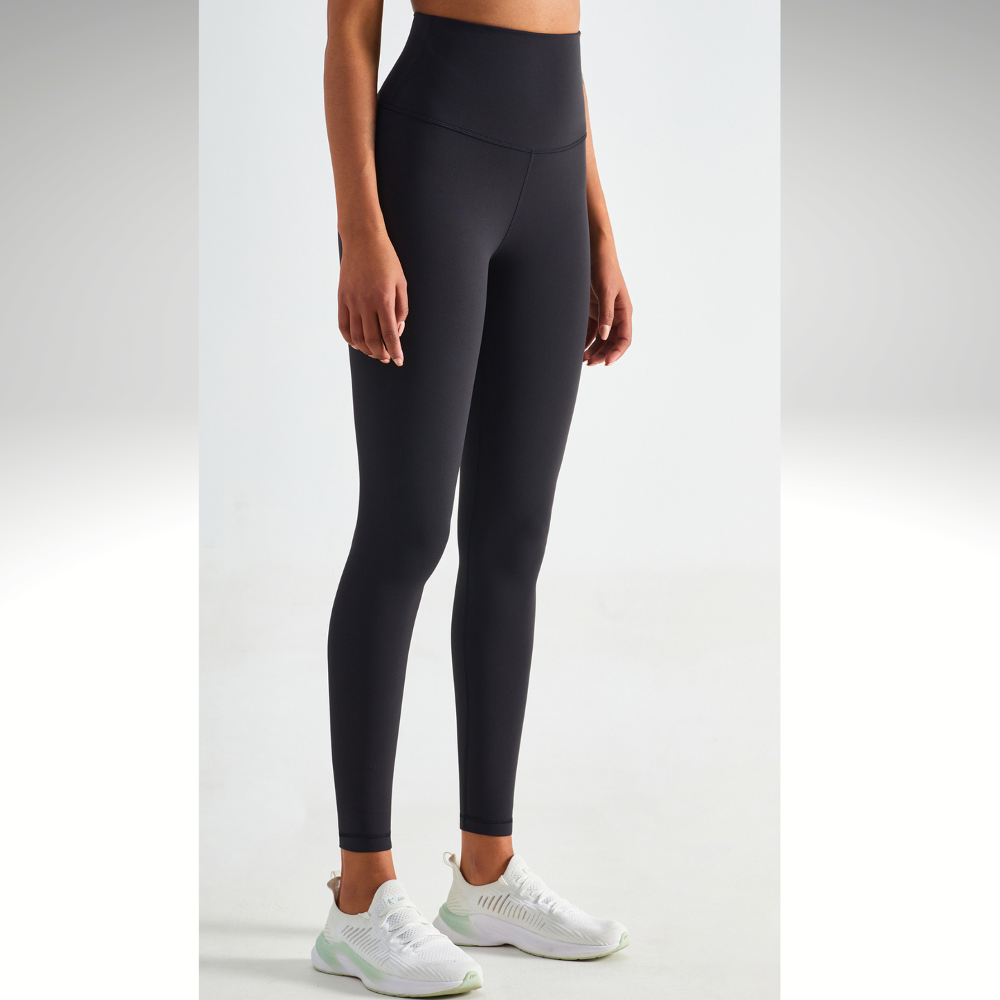 Person wearing black leggings on a white background