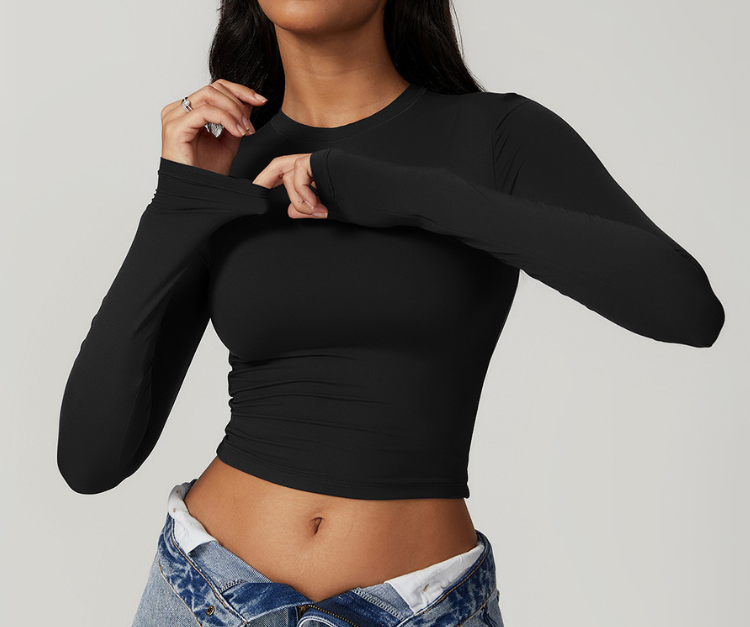 This sleek, fitted long sleeve crop top features buttery-soft, stretch fabric with thumbholes for extra support. Perfect for strength training, light cardio, yoga, and layering before or after workouts