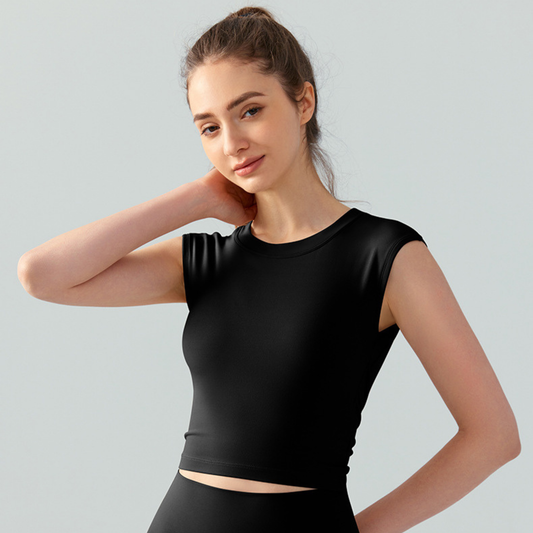 Woman wearing a black sleeveless top against a light gray background